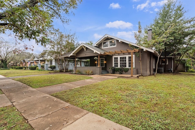 bungalow-style house featuring a front lawn and central AC unit