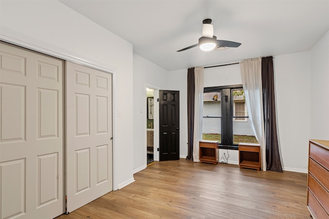 unfurnished bedroom featuring a closet, light hardwood / wood-style floors, and ceiling fan