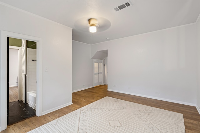 empty room with hardwood / wood-style flooring and ceiling fan