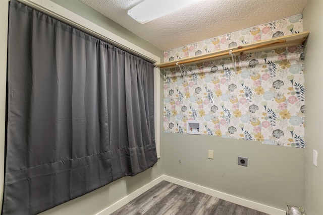 clothes washing area with hookup for a washing machine, electric dryer hookup, a textured ceiling, and hardwood / wood-style flooring