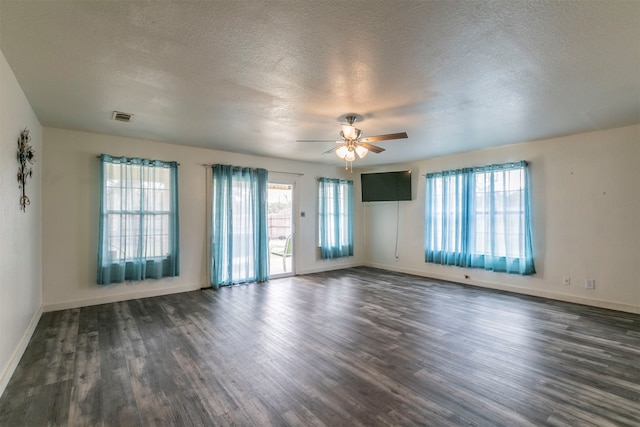 unfurnished room featuring dark hardwood / wood-style flooring, a textured ceiling, and ceiling fan