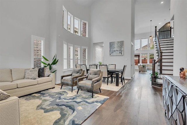 living room with a high ceiling and hardwood / wood-style floors