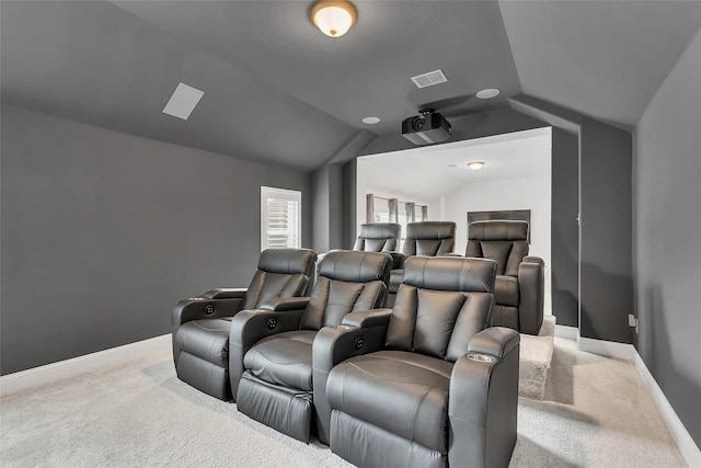 carpeted home theater room with lofted ceiling