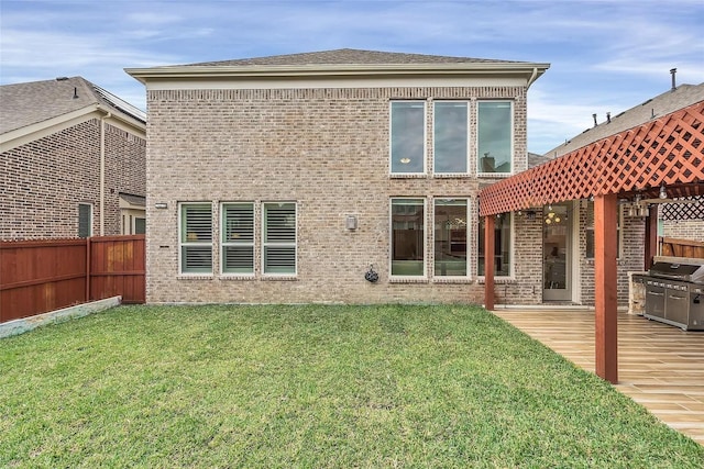 rear view of property with a lawn