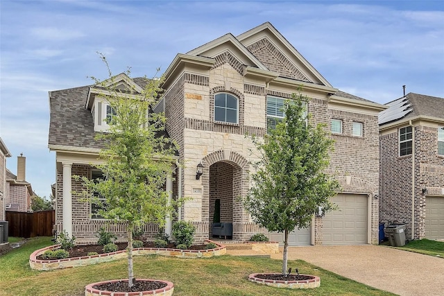 view of front of home with a front yard and a garage