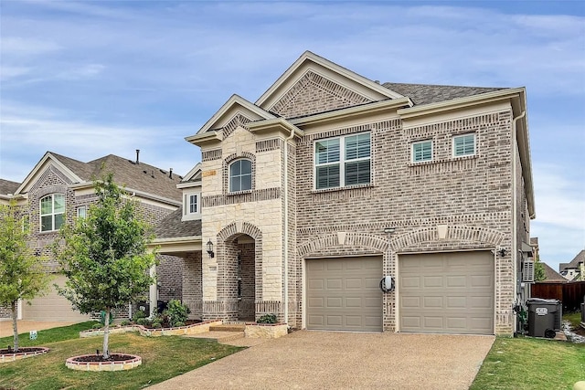 view of front of property with a front yard and a garage