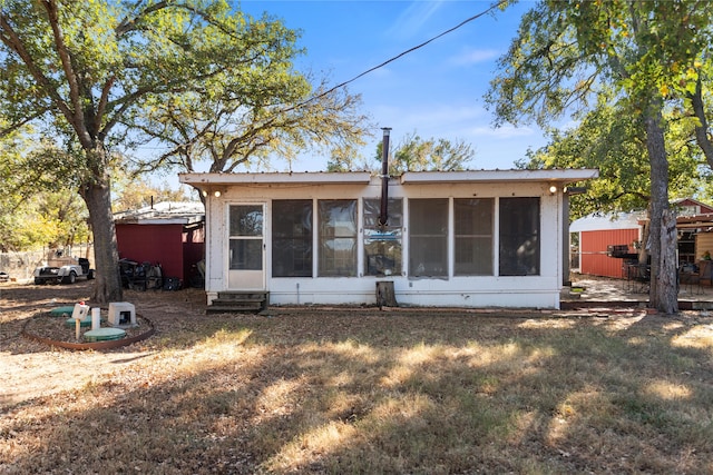 rear view of property with a sunroom