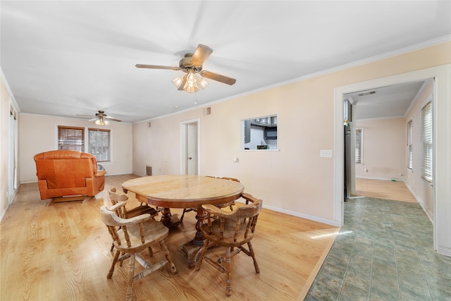 dining area featuring ceiling fan, light wood-type flooring, and ornamental molding