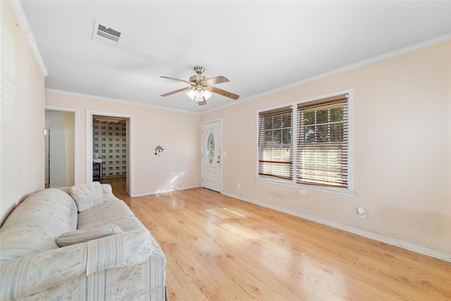 living room featuring light wood-type flooring, ceiling fan, and crown molding