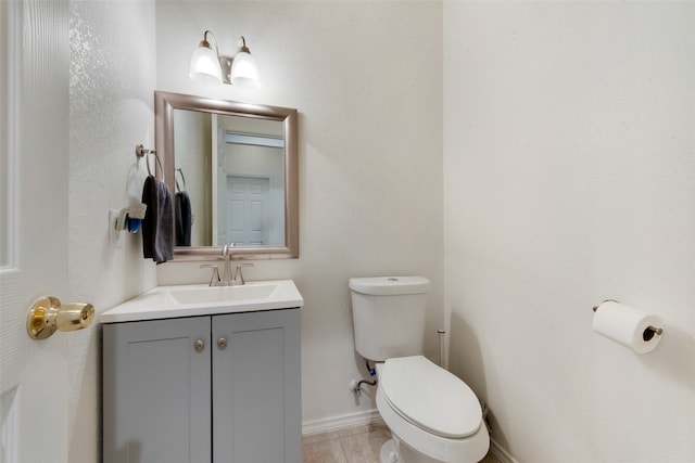 bathroom featuring tile patterned floors, vanity, and toilet