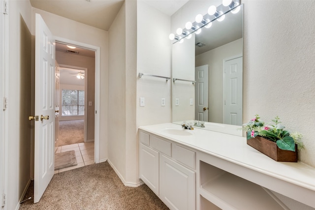 bathroom featuring tile patterned flooring, vanity, and ceiling fan