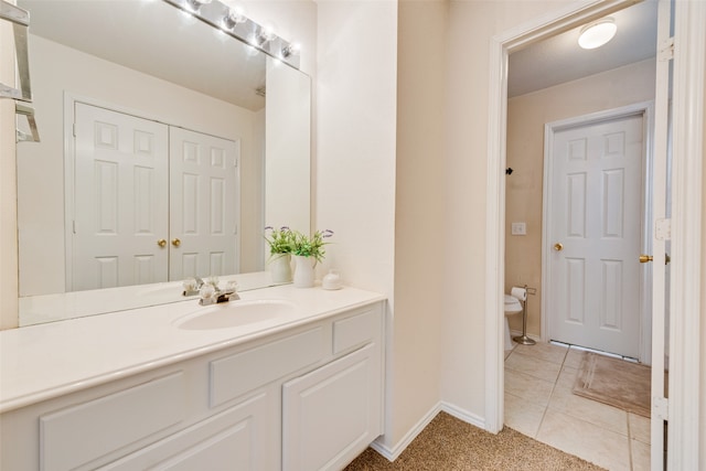 bathroom with vanity, tile patterned floors, and toilet