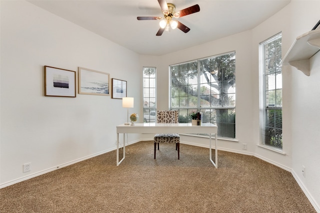 carpeted home office with plenty of natural light and ceiling fan