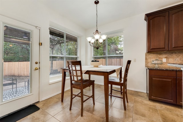 tiled dining space featuring an inviting chandelier