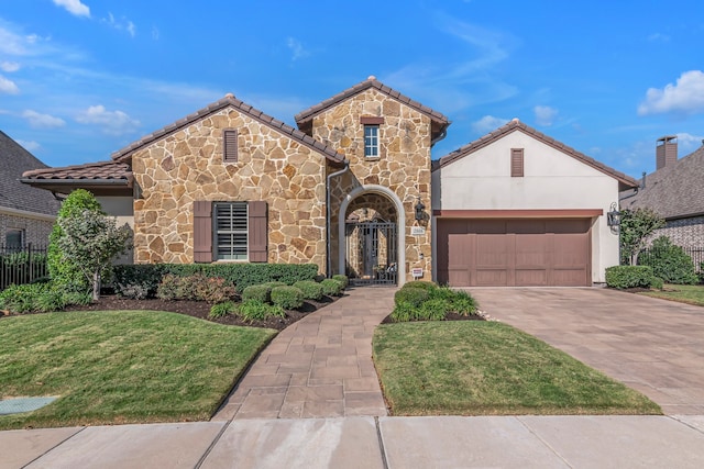 view of front of property with a garage and a front lawn