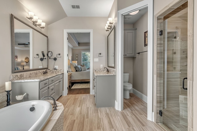 full bathroom with toilet, lofted ceiling, hardwood / wood-style floors, and separate shower and tub