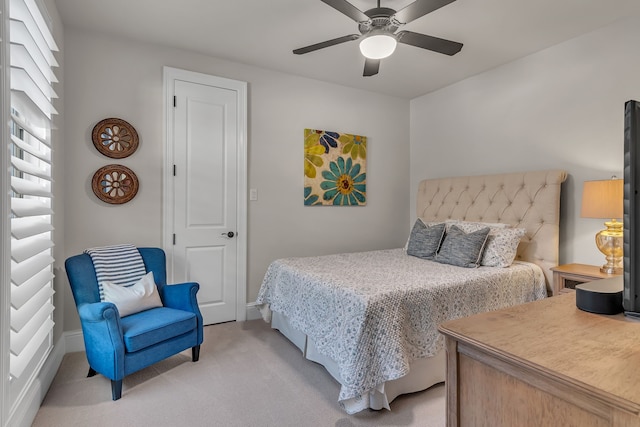 bedroom featuring light carpet and ceiling fan