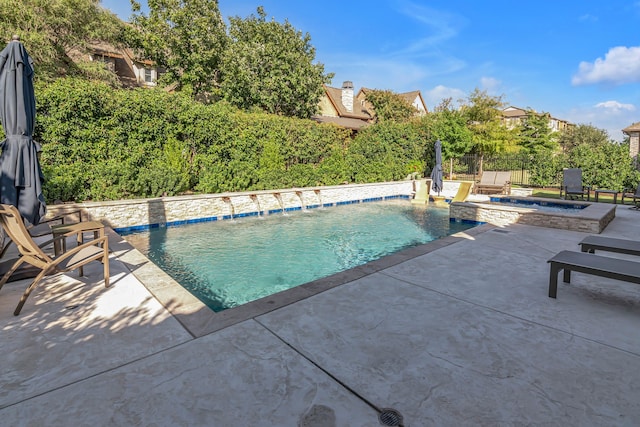 view of pool featuring pool water feature, a patio, and an in ground hot tub