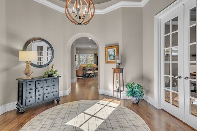 hallway featuring dark hardwood / wood-style flooring, french doors, and ornamental molding