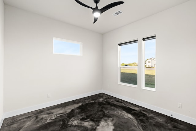 spare room featuring plenty of natural light and ceiling fan