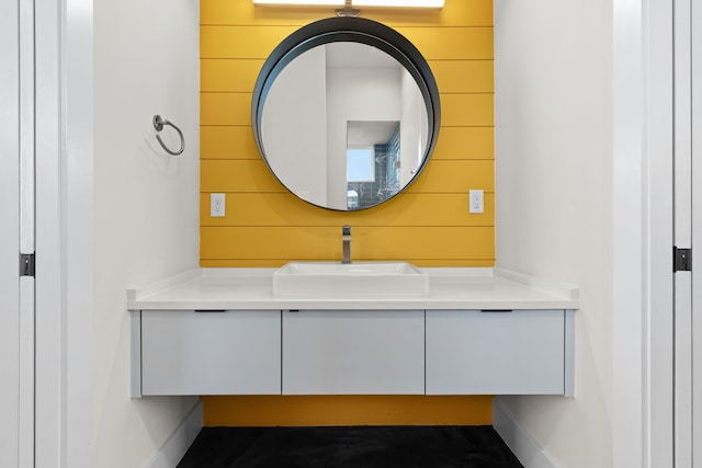 bathroom with wood walls and vanity