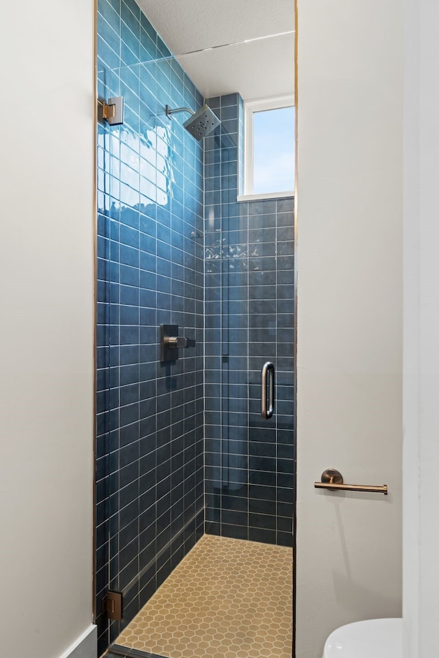 bathroom featuring an enclosed shower and toilet