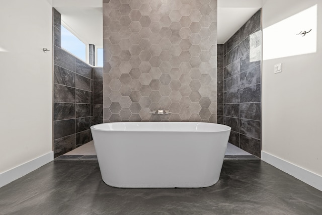 bathroom with tile walls, a bathing tub, and concrete floors