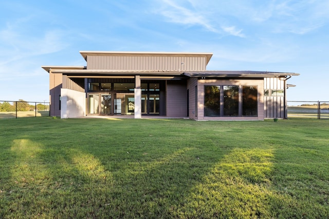 back of property featuring a lawn