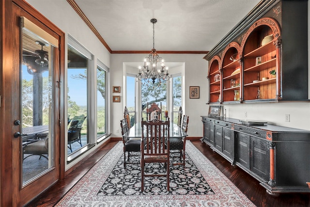 dining space with dark hardwood / wood-style flooring, ornamental molding, and plenty of natural light