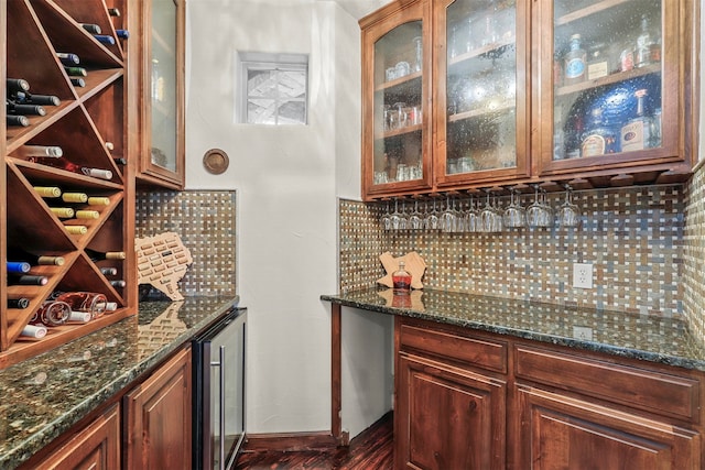 interior space with decorative backsplash, dark stone counters, dark hardwood / wood-style floors, and wine cooler