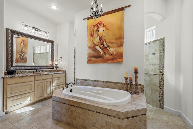 bathroom with a chandelier, plus walk in shower, vanity, and tile patterned floors