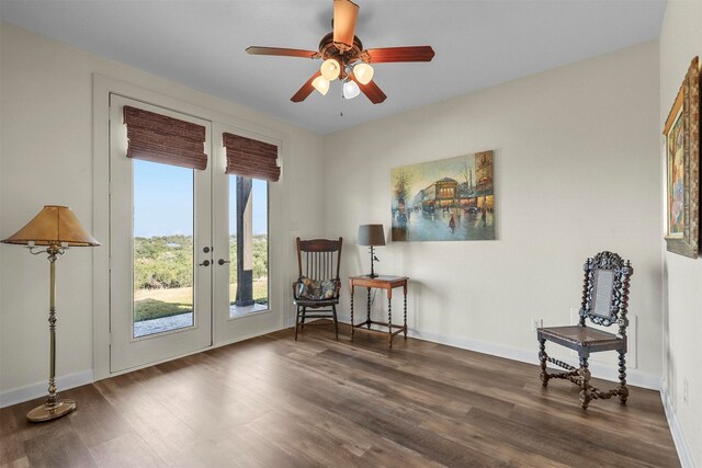 sitting room with french doors, dark wood-type flooring, and ceiling fan