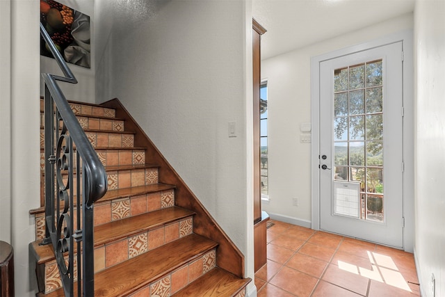 tiled foyer with a healthy amount of sunlight