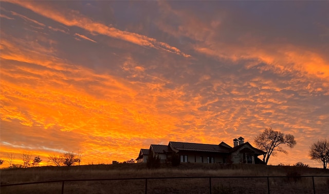 view of back house at dusk