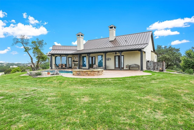 rear view of house with a yard and a patio area