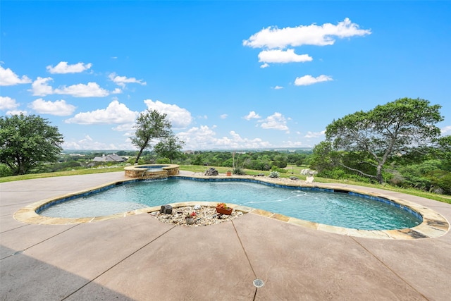 view of pool featuring a patio and an in ground hot tub