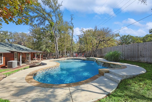 view of swimming pool with pool water feature, cooling unit, and a patio