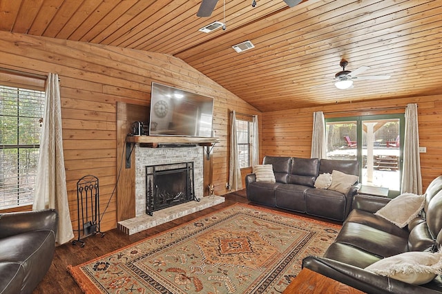 living room featuring ceiling fan, dark hardwood / wood-style flooring, wooden ceiling, and plenty of natural light