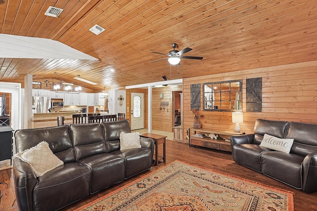 living room with wood ceiling, vaulted ceiling, ceiling fan, dark wood-type flooring, and wood walls