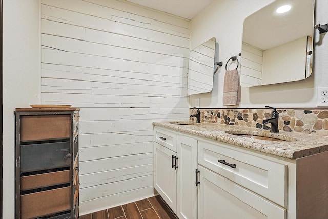 bathroom featuring vanity and wooden walls