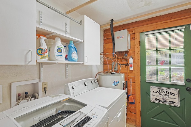 laundry room with cabinets, washer and dryer, and electric water heater