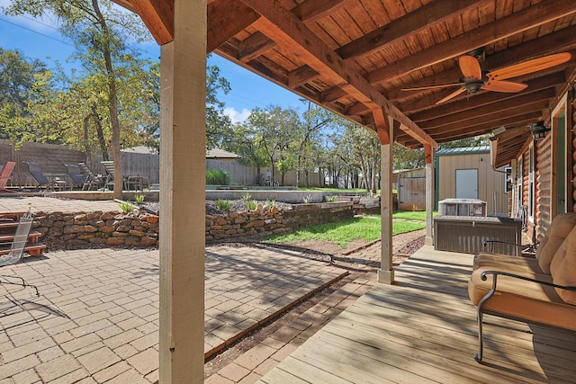 view of patio / terrace with ceiling fan and a storage shed