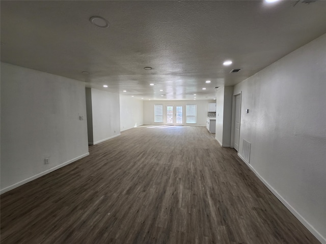 spare room featuring dark wood-type flooring and french doors