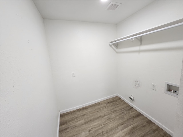 laundry area with hookup for an electric dryer, hookup for a washing machine, and hardwood / wood-style flooring