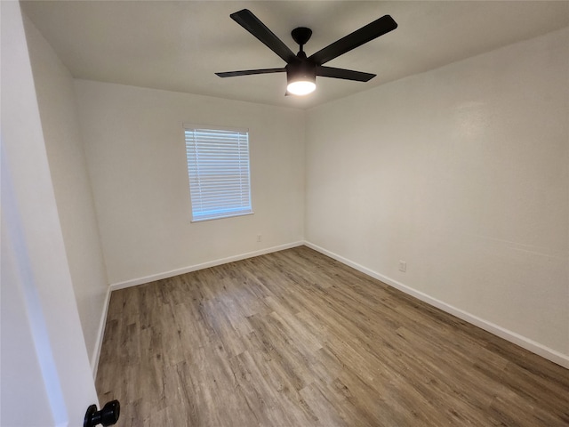 empty room featuring hardwood / wood-style flooring and ceiling fan