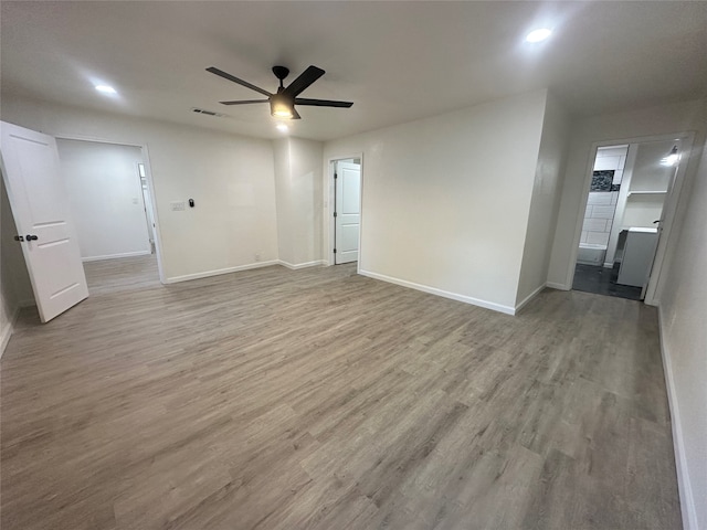 unfurnished room with light wood-type flooring and ceiling fan