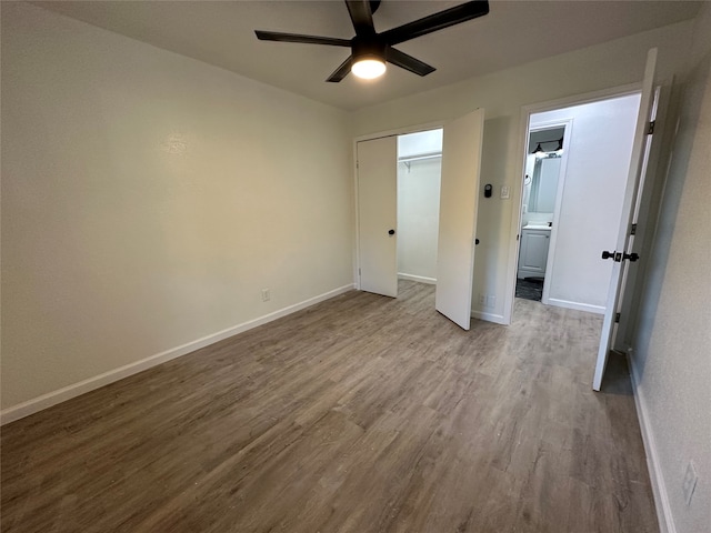 unfurnished bedroom featuring a closet, light wood-type flooring, and ceiling fan