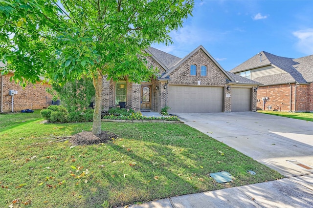 view of front of property with a garage and a front lawn