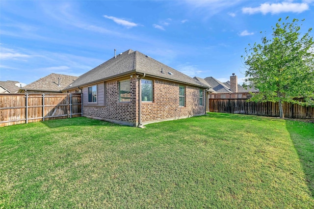 rear view of house with a yard