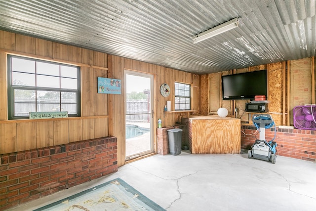 interior space with wood walls and concrete floors